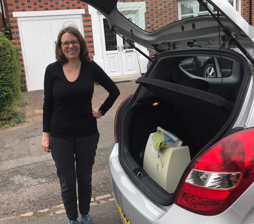 A volunteer loading her car while volunteering during COVID-19