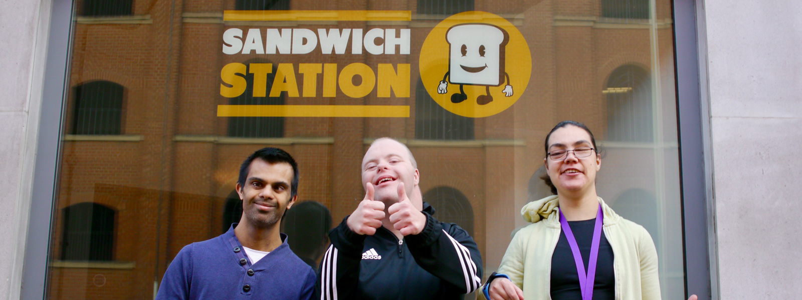 People with learning disabilities standing outside a sandwich shop