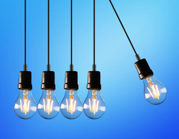 Image of 5 lit hanging lightbulbs against a blue background