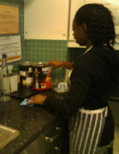 A person with learning disabilities working in a kitchen